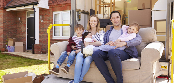 family on couch in moving truck